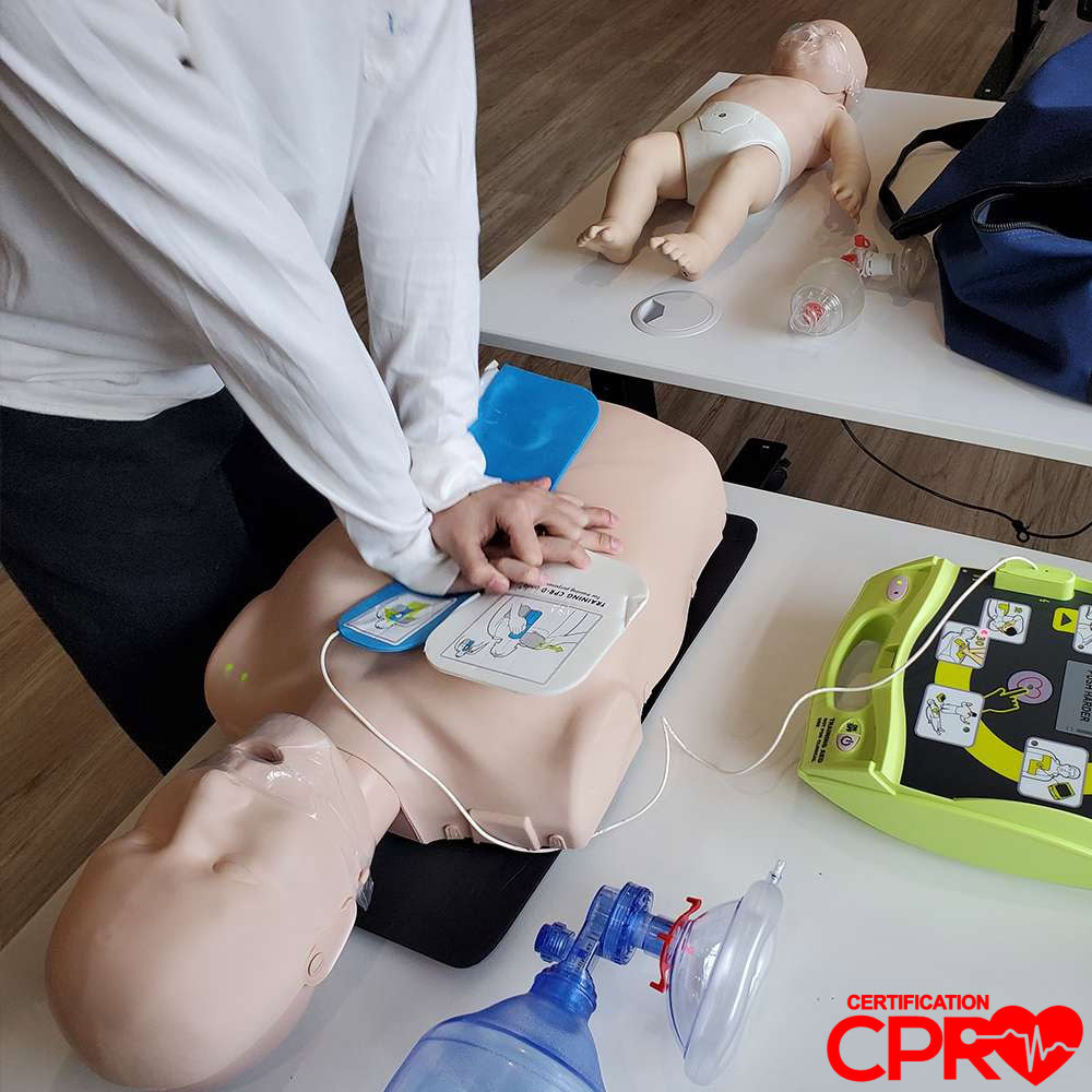 CPR training with mannequin and AED for certification in Denver.
