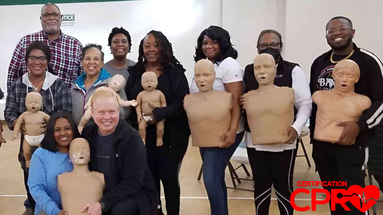 Group CPR training session in Denver with mannequins for certification.