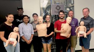 Group CPR training session with mannequins in Denver.