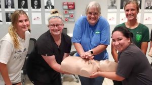 Group CPR training session in Denver with instructor and students.