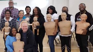 Group CPR training session with mannequins in Denver.