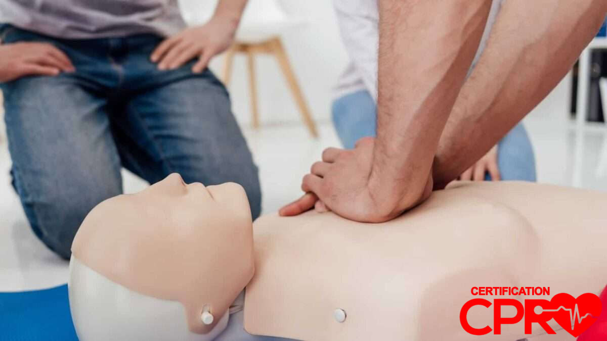 CPR training session with a man practicing on a mannequin in Denver.